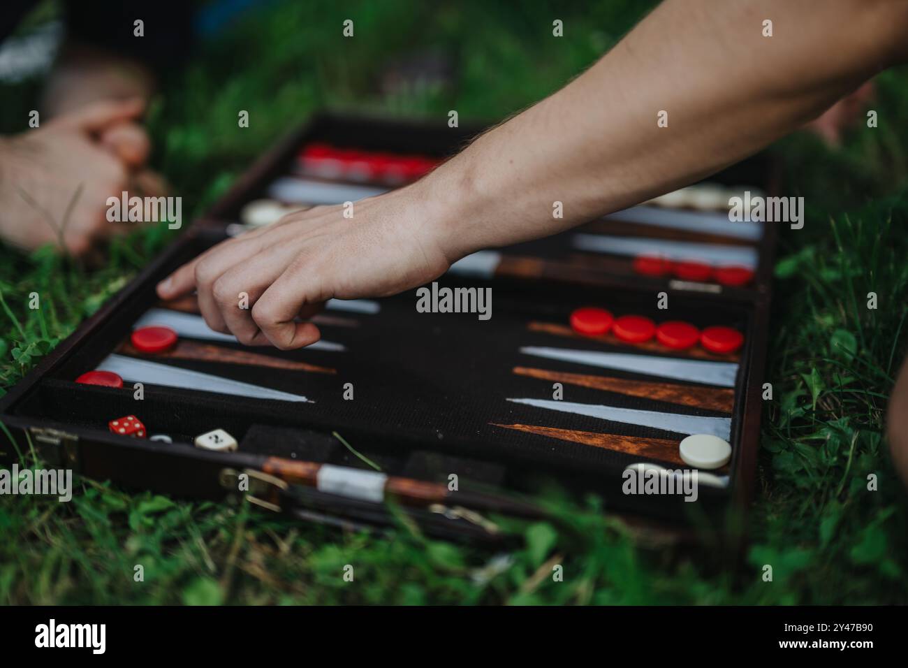 Outdoor backgammon game with friends on a grassy field Stock Photo - Alamy