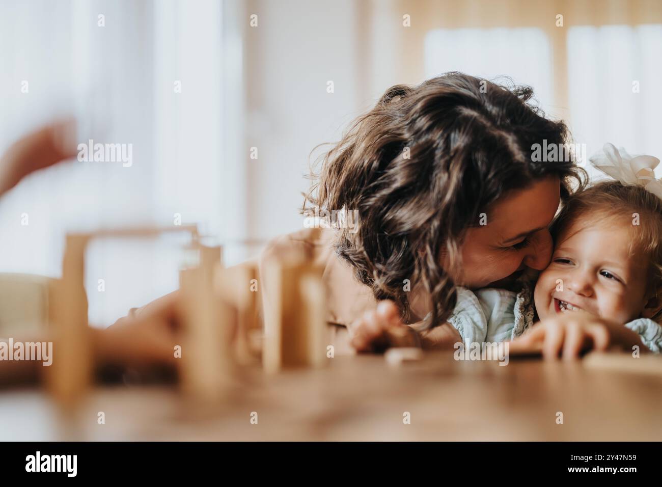 happy-mom-and-daughters-sharing-a-playful-moment-at-home-stock-photo