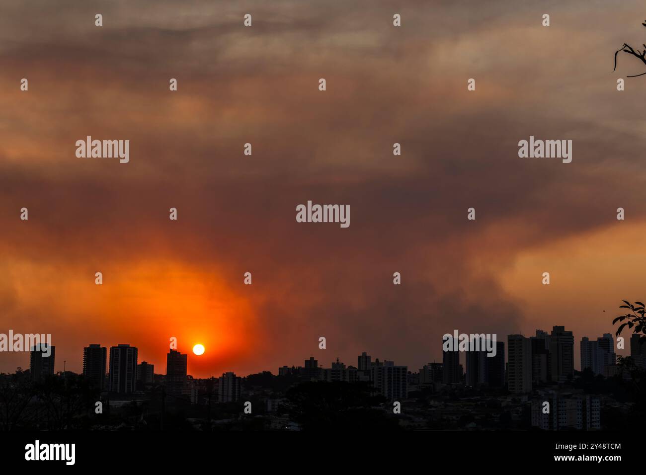 A thick layer of smoke covered the brazilian city during the late afternoon. The hot, dry weather and the air heavy with smoke make it harder for peop Stock Photo