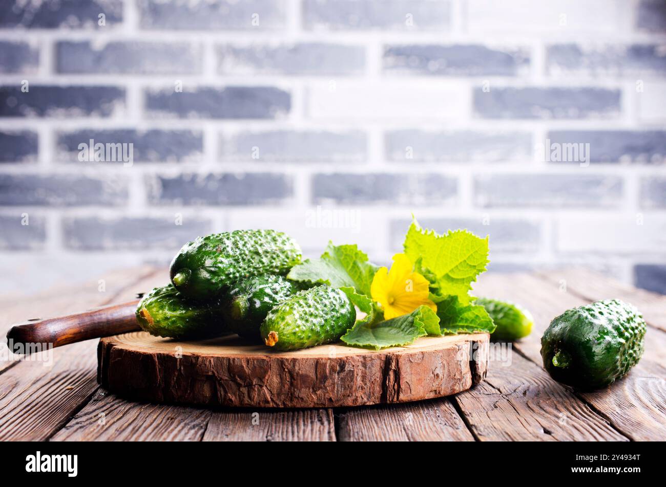 cucumbers on wooden cutting board, fresh organic vegetable food Stock Photo