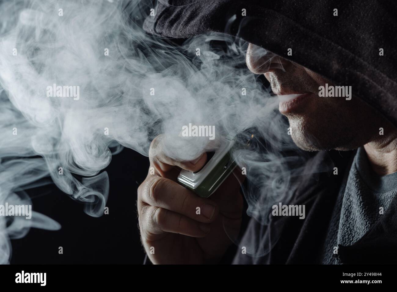 inhaling vape smoke 14,114 Inhaling Vape Royalty-Free Images, Stock Photos & Pictures main image 0