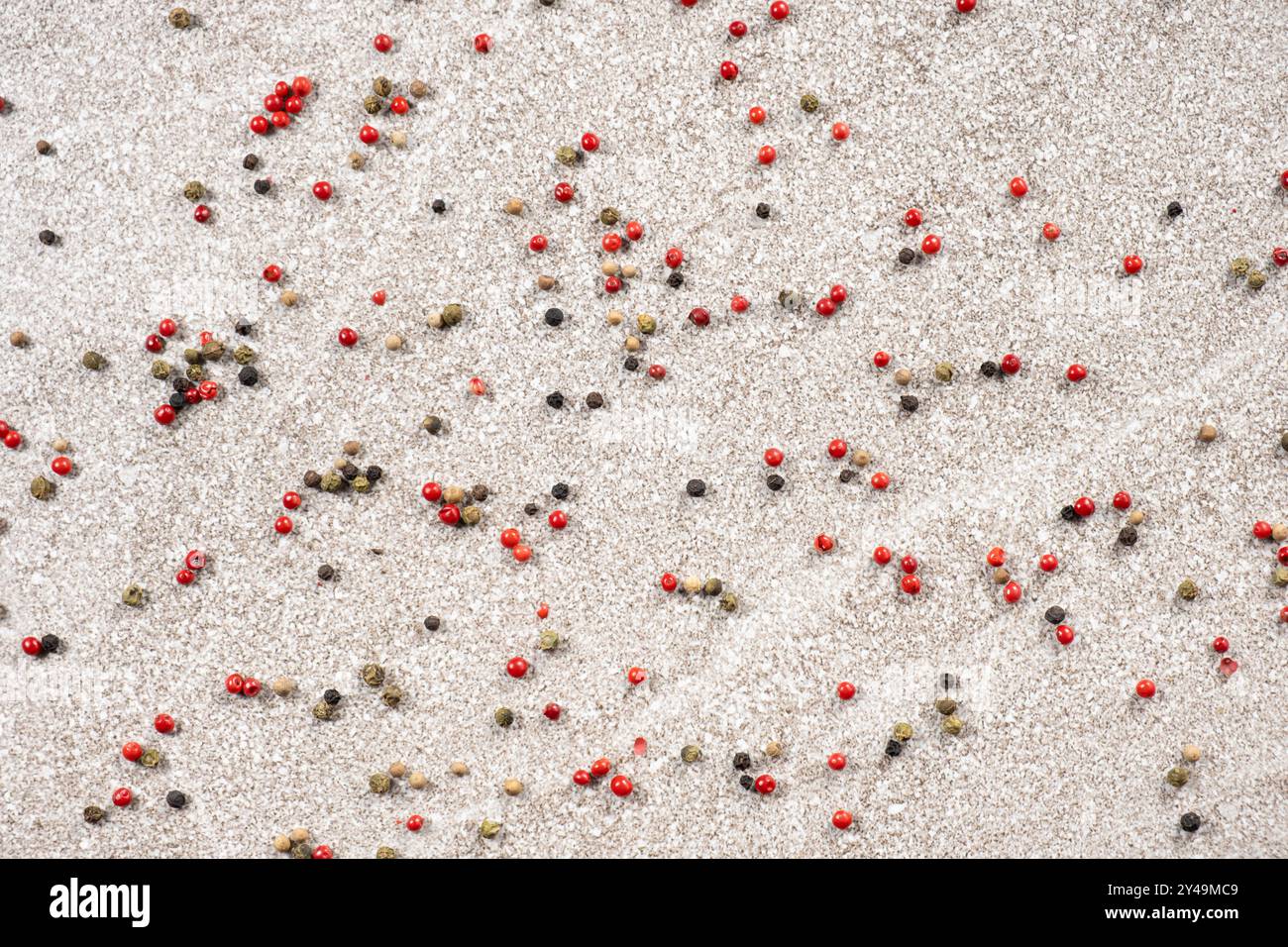 Multicolored peppercorns on a stone gray background. Stock Photo