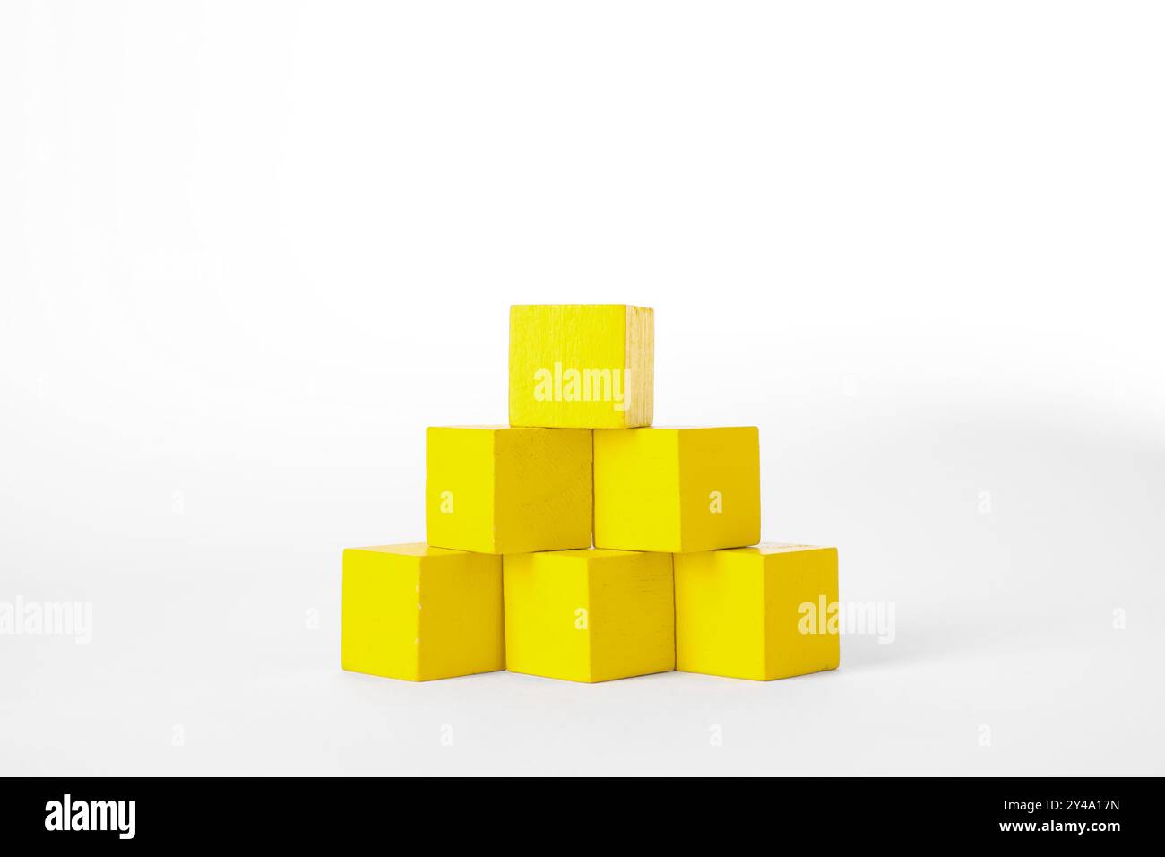 Many yellow wooden cubes isolated on white Stock Photo - Alamy