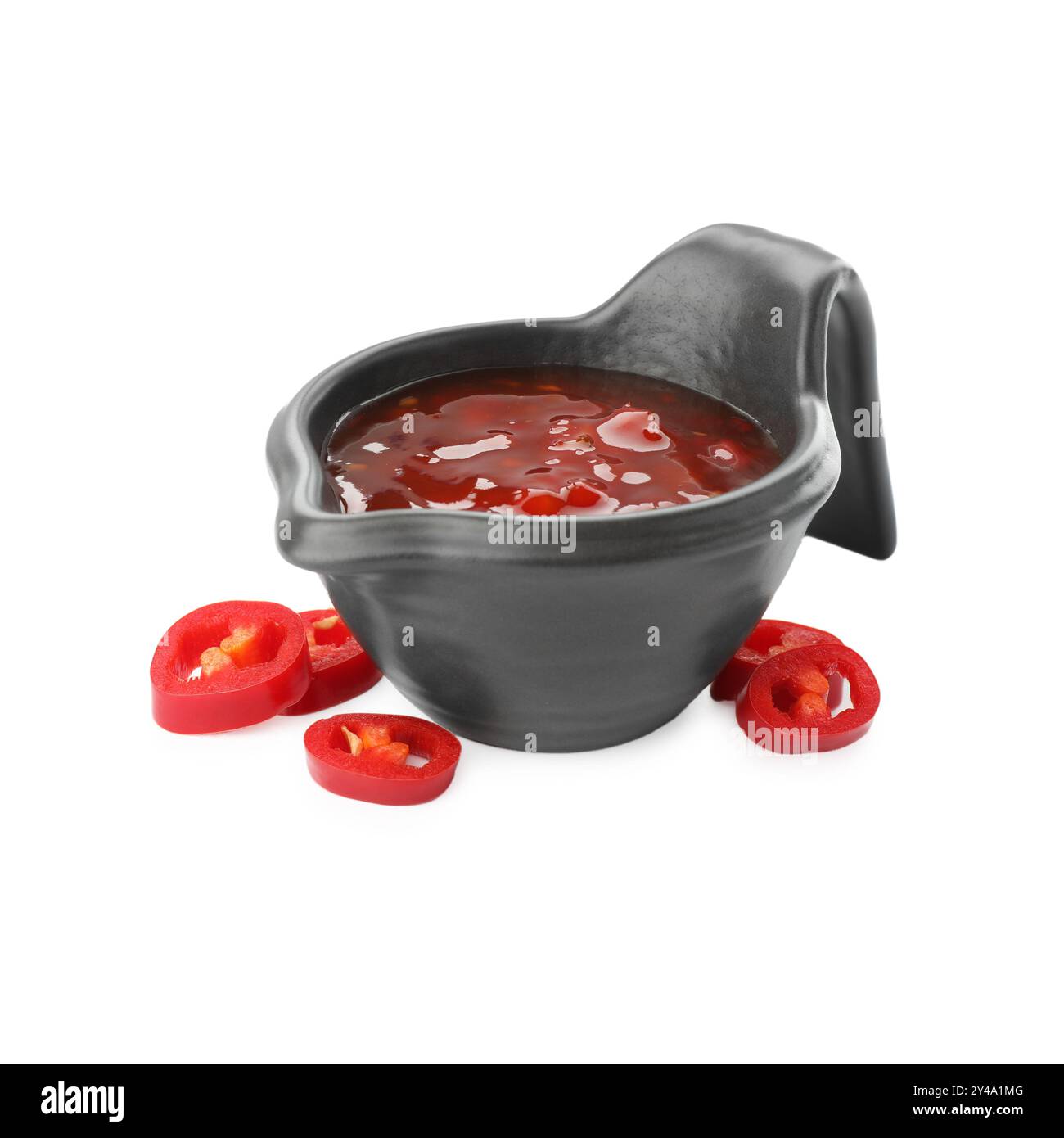 Hot chili sauce in gravy boat and pepper isolated on white Stock Photo