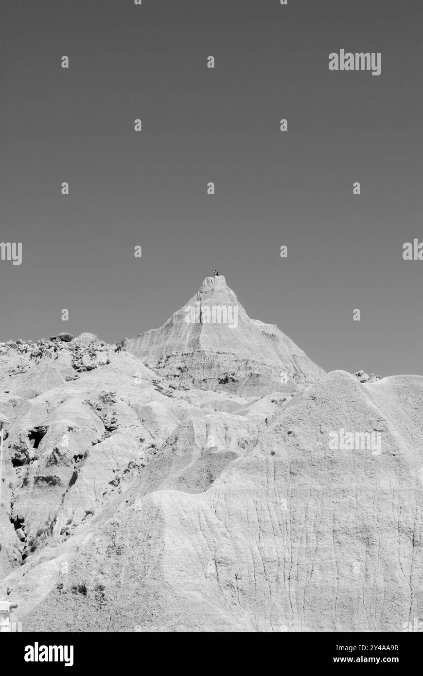 Tourists standing on top of a high peak at Badlands National Park, Interior, South Dakota, USA. Stock Photo