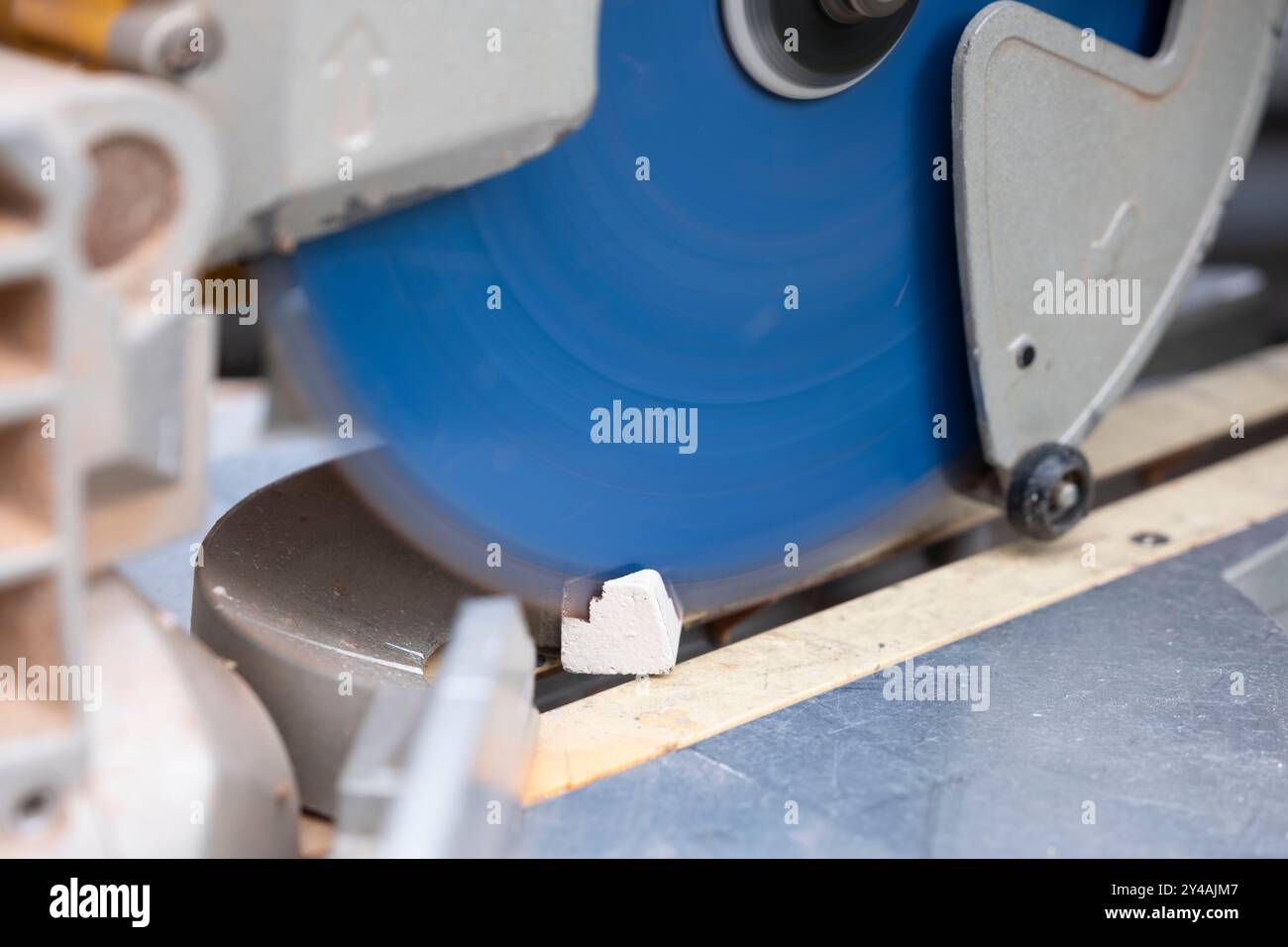 A slat is sawn off at an angle with a circular cross-cut saw Stock ...