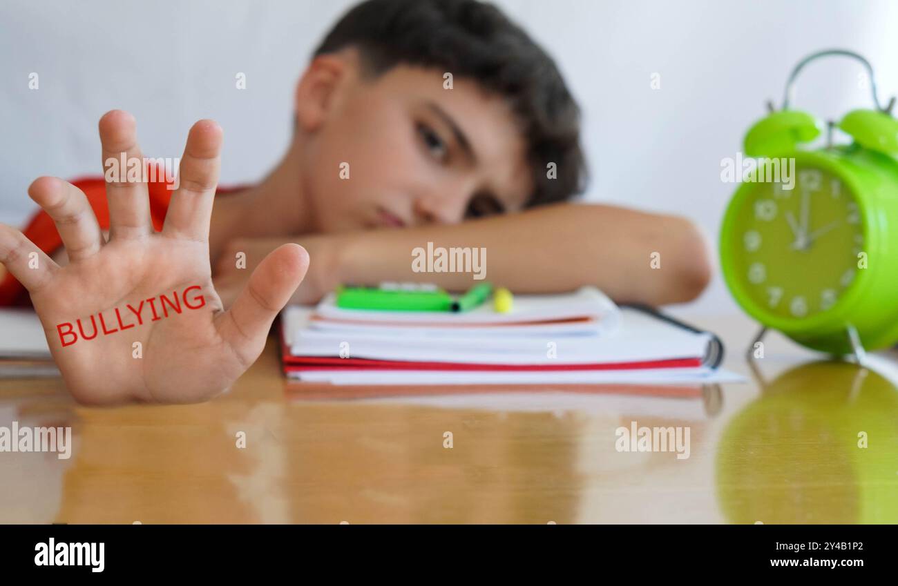 BULLYING, palm of child's hand with books and notebooks and worried and ...