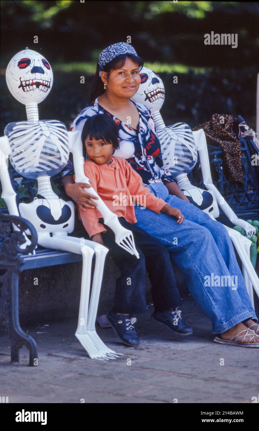 Mexico, Queretaro. Dia de los Muertos (Day of the Dead) Mother and child with skeletons for All Soul's Day. Stock Photo