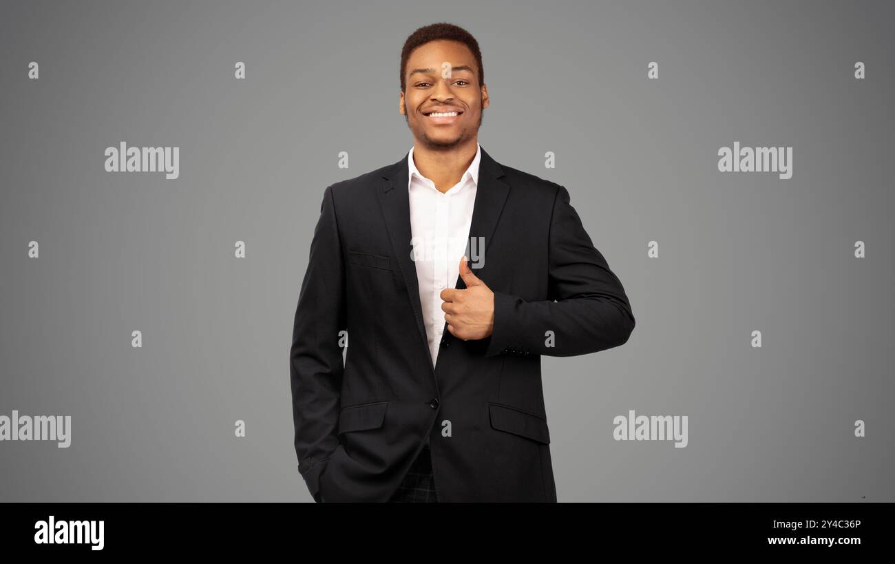 Afro guy showing thumb up and smiling Stock Photo
