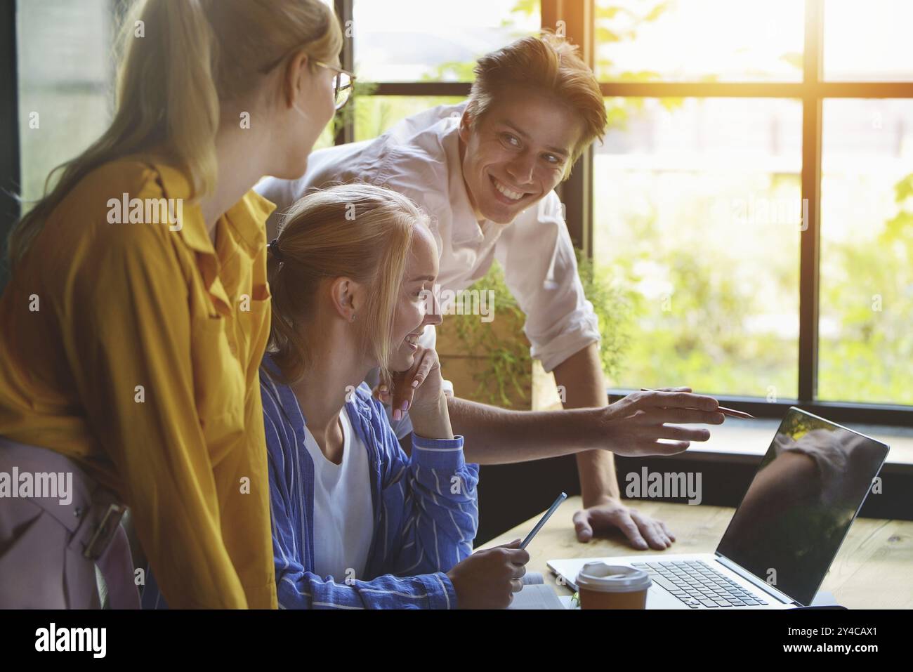 Group of colleagues having meeting in boardroom while working on big presentation and preparing their business strategy. Creative designers looking br Stock Photo