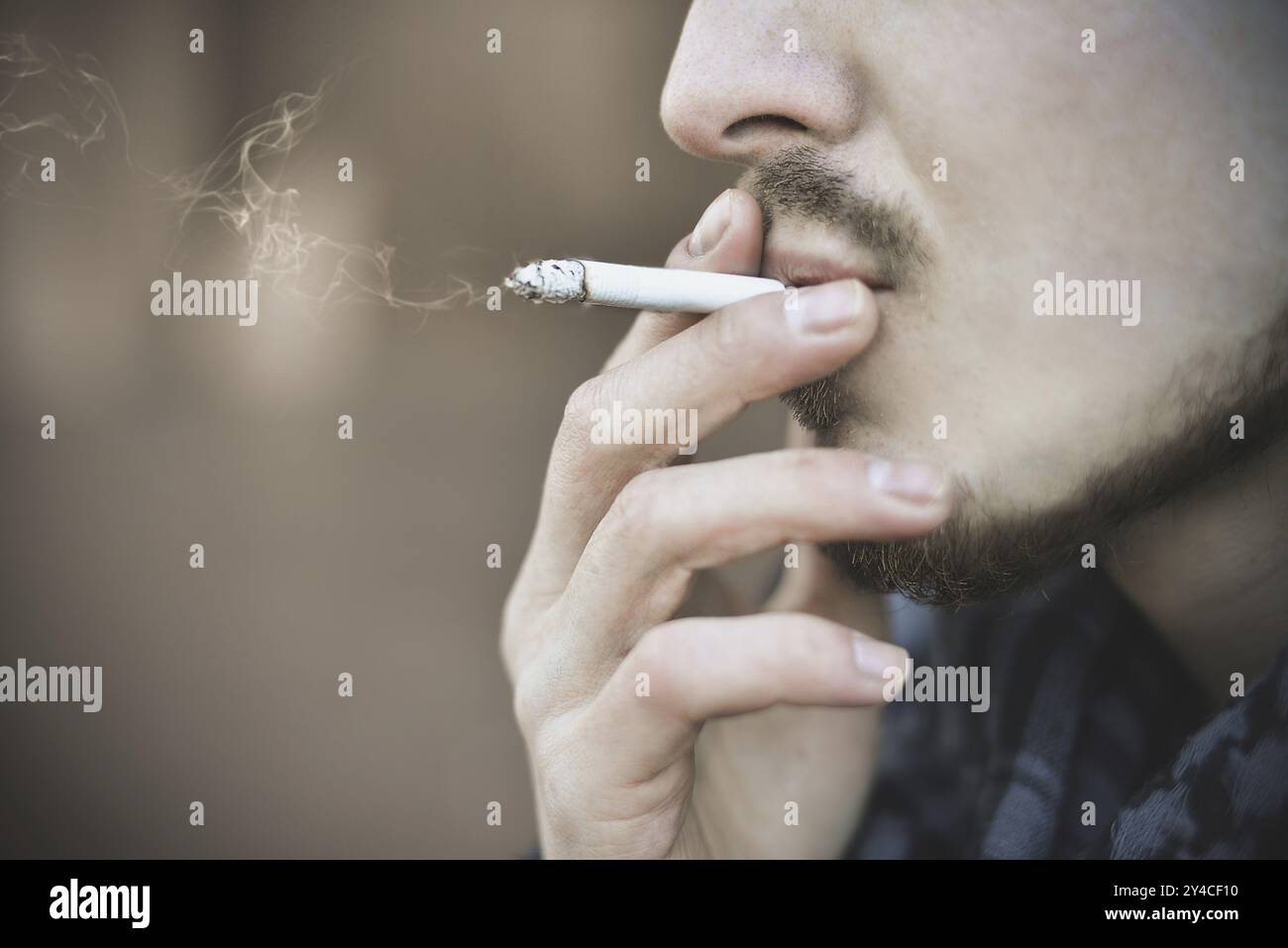 Man smoking cigarette Close up of an smoking cigarette Stock Photo