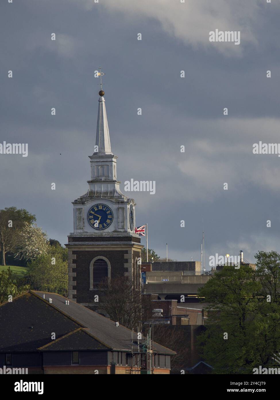 Close-up of a church tower with a clock under a cloudy sky, themse, . tilbury, England, Great Britain Stock Photo