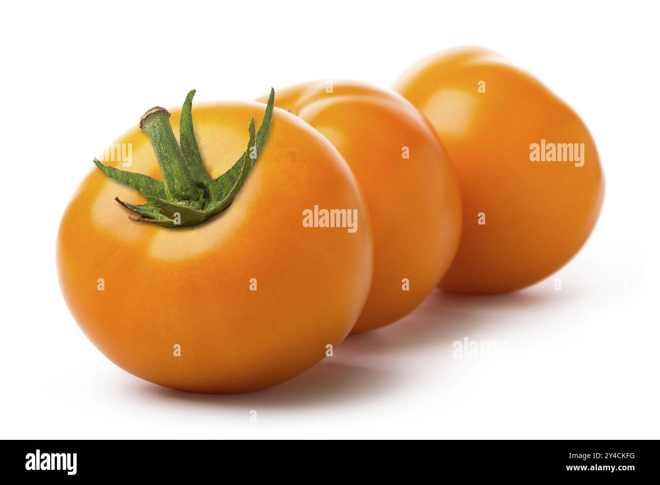 Three yellow tomatoes isolated on a white background Stock Photo