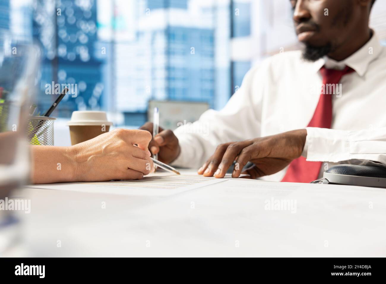 Worker with paraplegia attending corporate training session, engaged in continuous learning and career advancement in inclusive workplace. Wheelchair user at work receiving equal chances Stock Photo