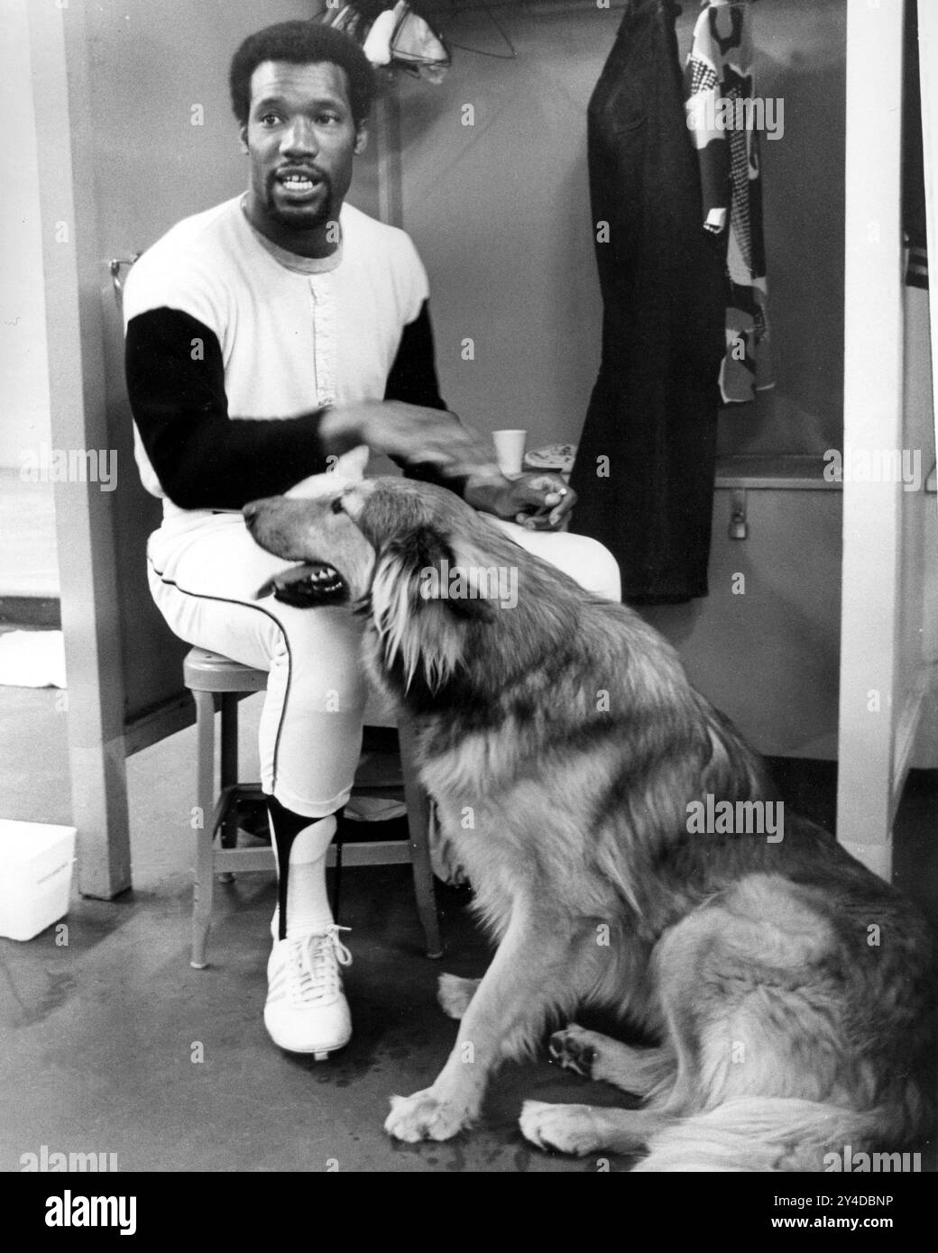 Giants outfielder Bobby Bonds in the locker room with his dog 