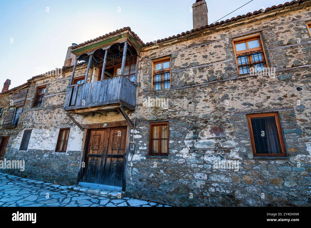 Greek Stone Railing A traditional stone house in Elati, Trikala, Greece, featuring a wooden ...