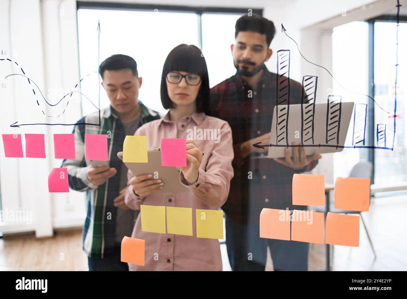 Team brainstorming session with sticky notes and graphs Stock Photo - Alamy