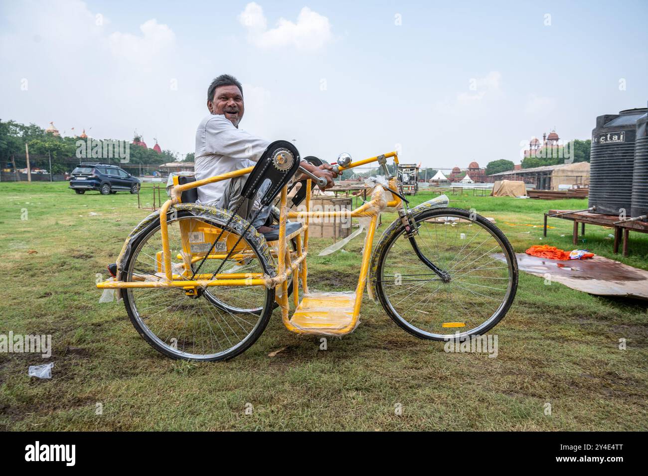 A disabled man rides his new handicapped manual tricycle which he A disabled man rides his new handicapped manual tricycle which he