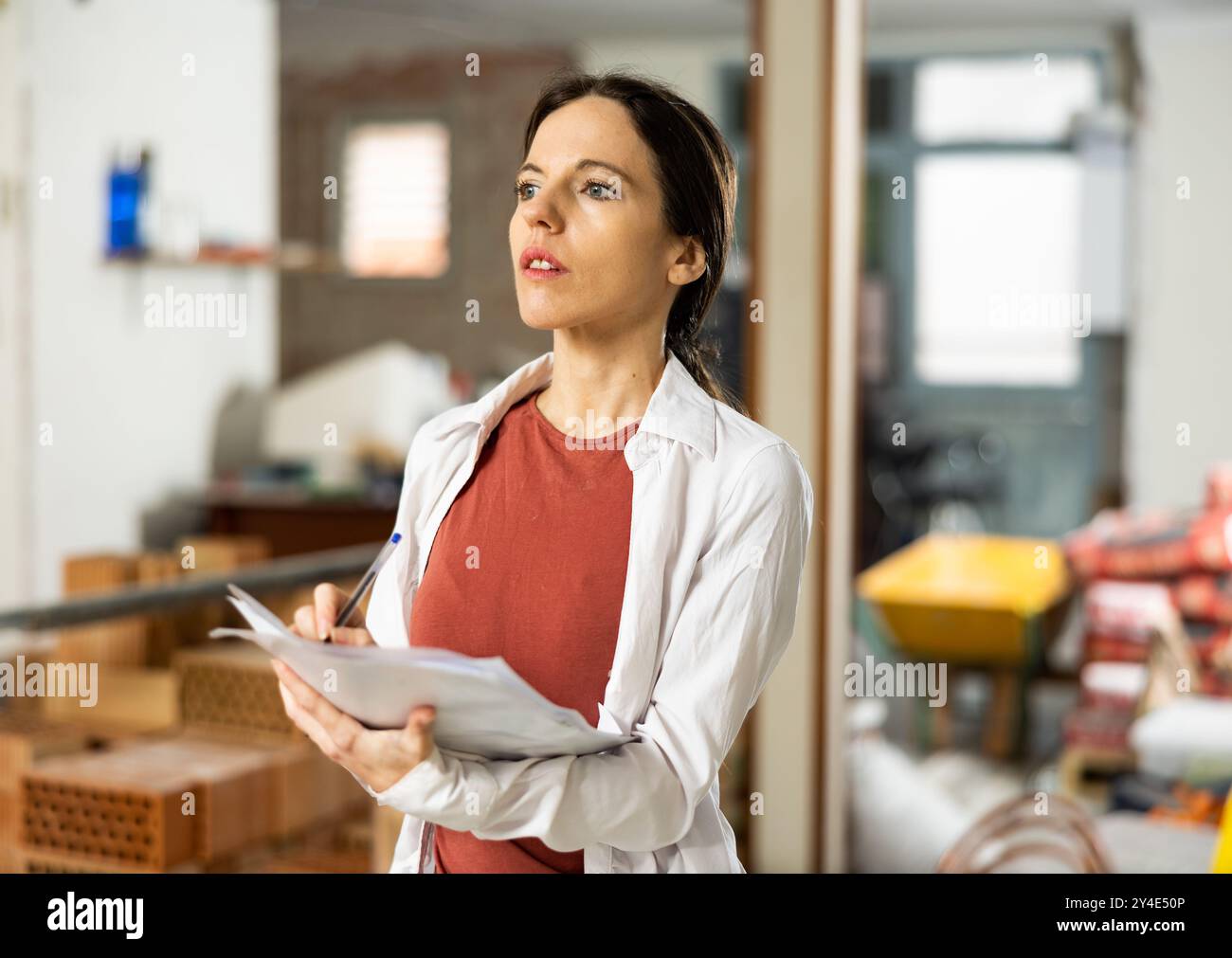 Architect woman checks according to the plan completed repair work ...
