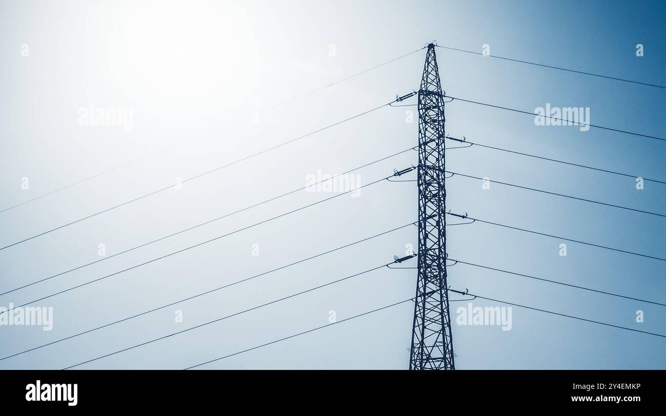 Tall electricity transmission structure stands against a blue sky Stock ...