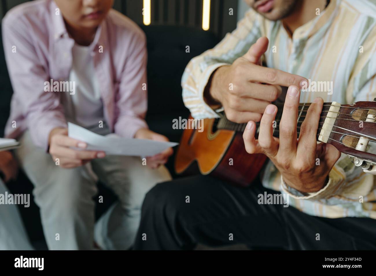 Strumming Acoustic Guitar for Teaching Lesson Stock Photo