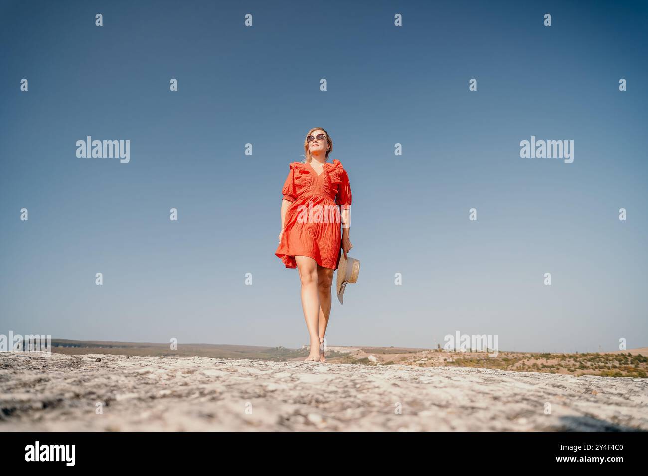 Woman in Red Dress Walking on a Rocky Path Stock Photo - Alamy