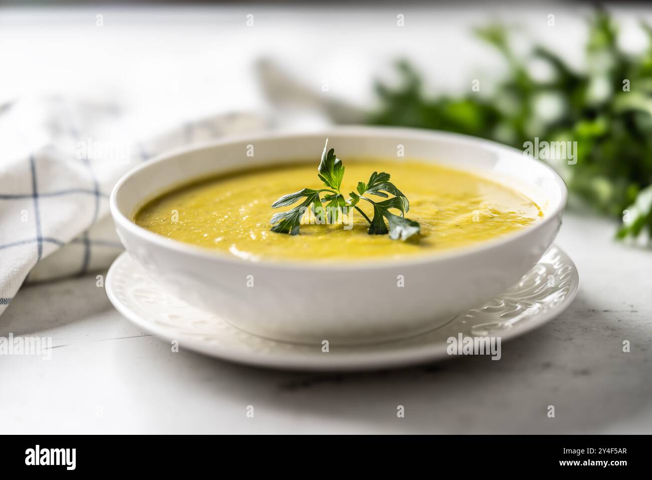 Healthy creamy vegetable soup in a white bowl. Stock Photo