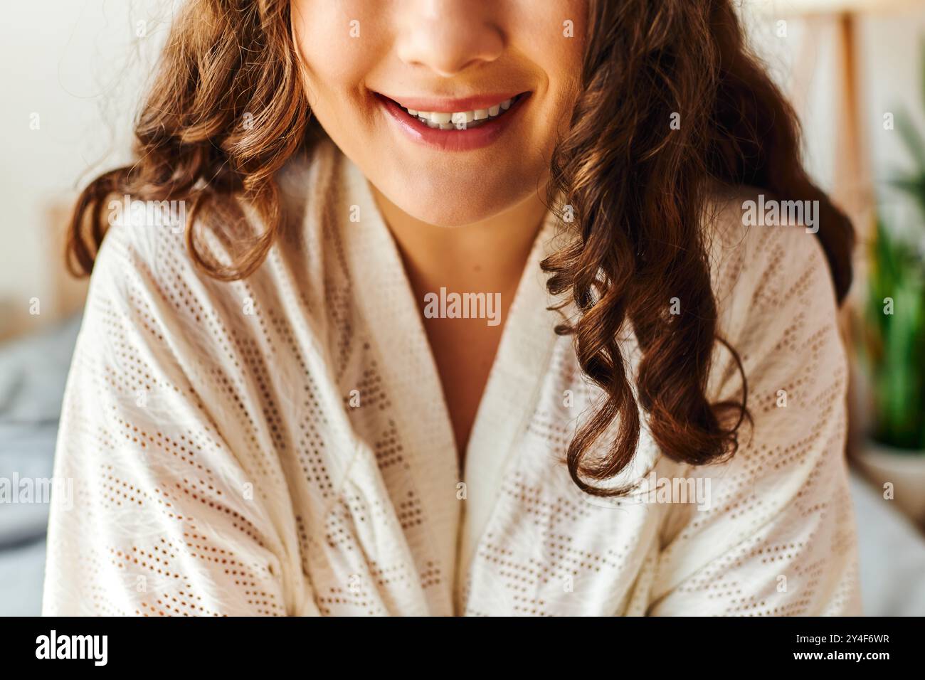 Bright and cheerful, a young woman embraces the comfort of her home ...