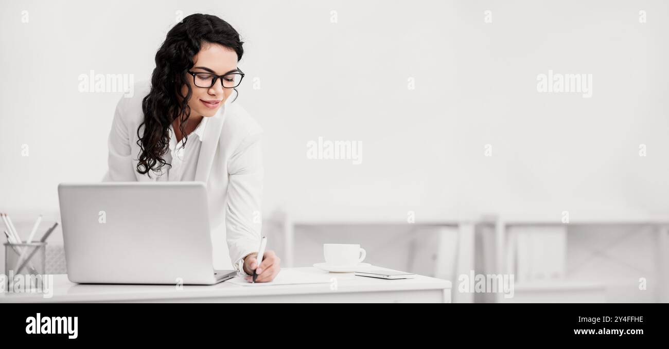 Mexican woman taking down some notes and ideas Stock Photo