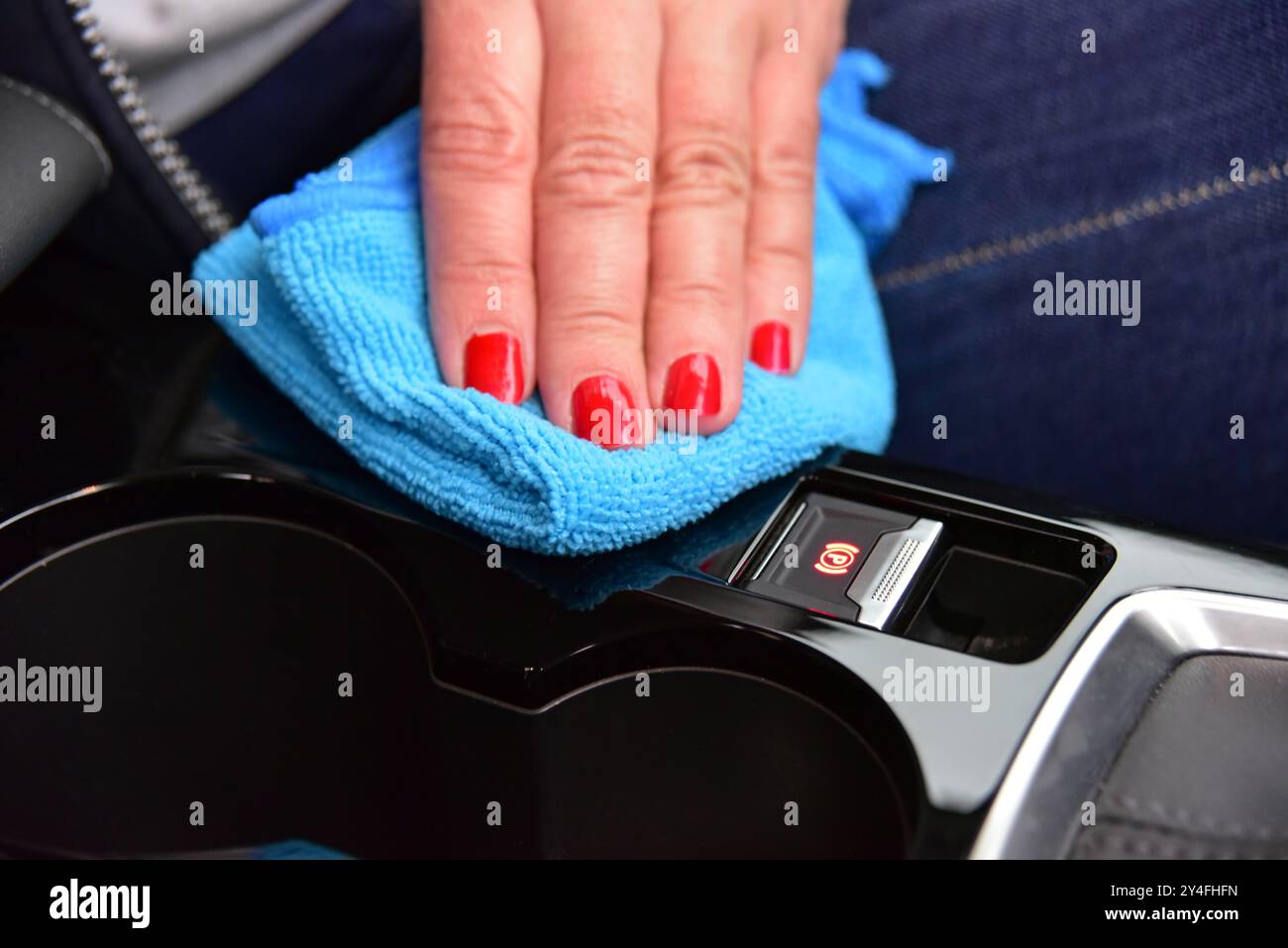 Cleaning the car console with a microfiber cloth Stock Photo - Alamy
