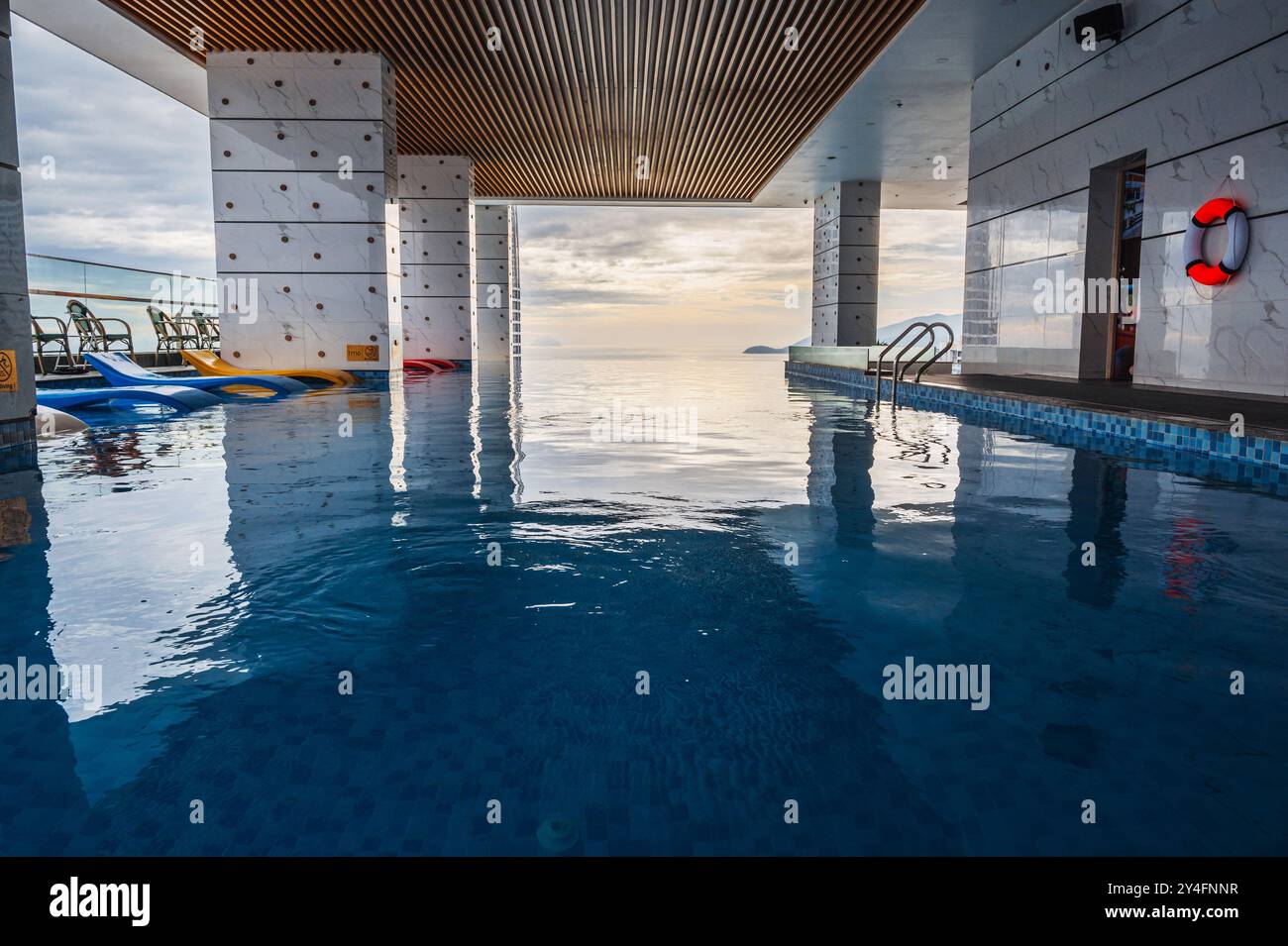 interior of a luxury skyscraper hotel with rooftop pool overlooking the ...