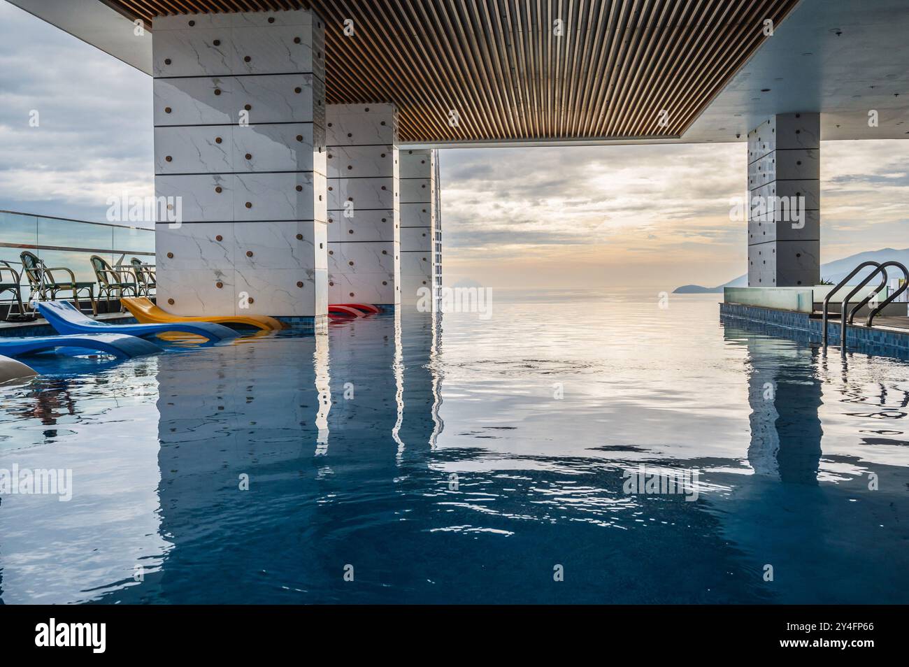 interior of a luxury skyscraper hotel with rooftop pool overlooking the ...