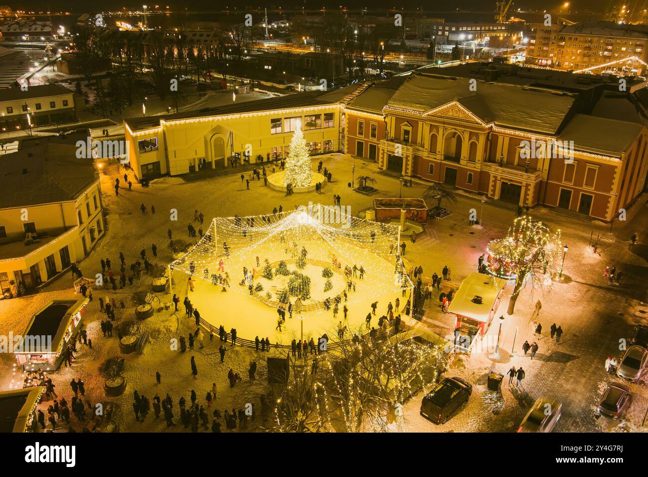 Nighttime aerial view of decorated and illuminated Christmas tree on the Teatro Square in Klaipeda. Celebrating Christmas and New Year in coastal city Stock Photo