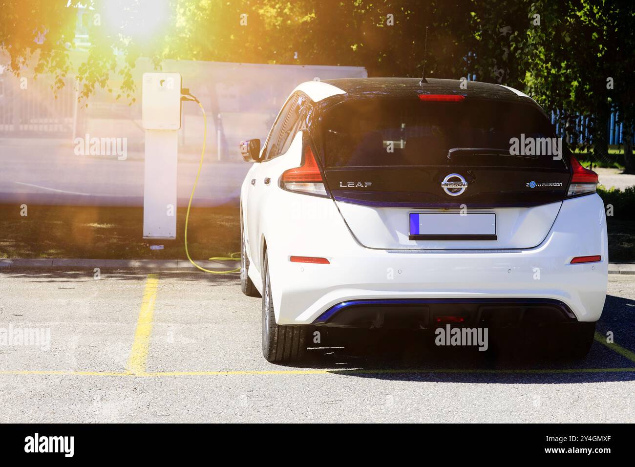 White Nissan Leaf battery electric car charging battery at the vehicle dealership. Salo, Finland. June 22, 2024. Stock Photo