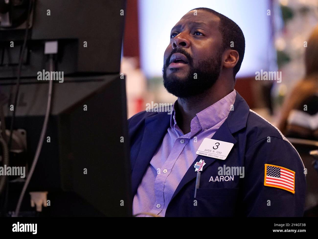 Trader Aaron Ford works on the floor of the New York Stock Exchange ...