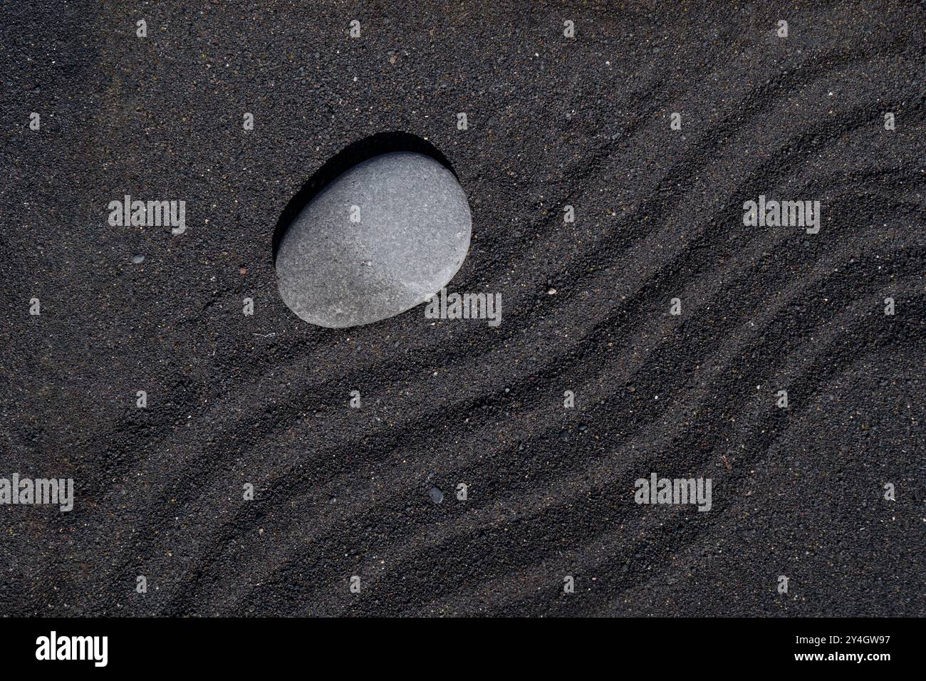 Hope stone on black sand Stock Photo