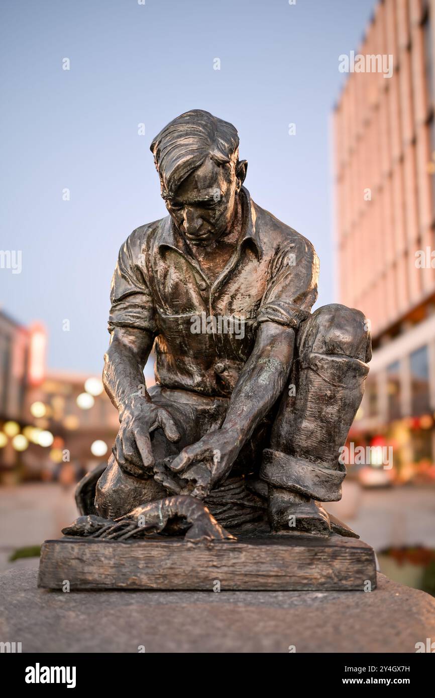 WASHINGTON DC, United States — The Lobsterman sculpture stands at The Wharf development along the Southwest Waterfront. This bronze figure pays tribute to the fishing industry and serves as a cultural connection between Washington's waterfront and America's maritime heritage. The statue is a replica of Victor Kahill's original Maine Lobsterman. Stock Photo