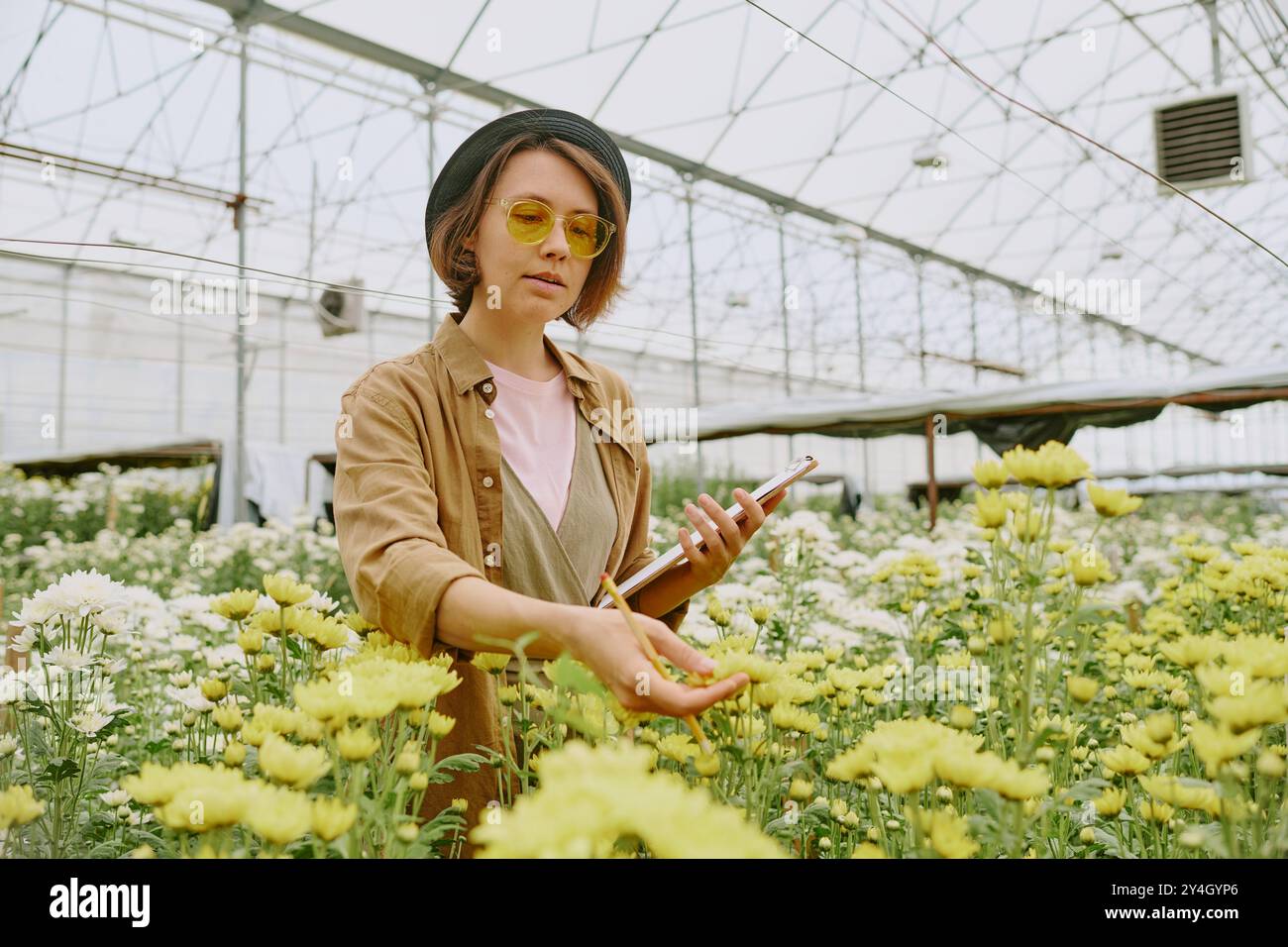 Exploring Nature in a Greenhouse with Tablet Stock Photo
