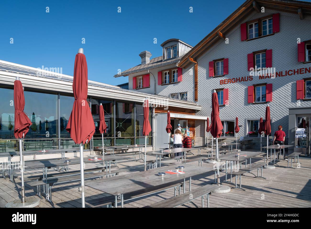 Mannlichen, Switzerland - July 24, 2024: Berghaus outdoor cafeteria seating area and restaurant up at Mannlichen area Stock Photo