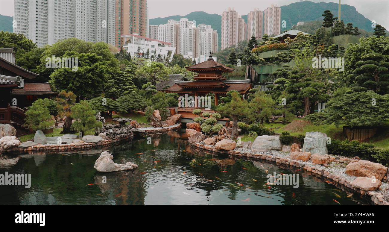 Serene Asian garden with traditional pavilion, lush greenery, and koi ...