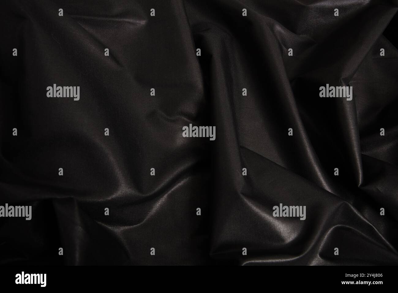 Blac silk textile background. Satin fabric texture, Luxury wavy backdrop. Stock Photo