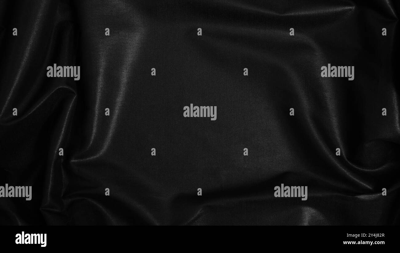 Blac silk textile background. Satin fabric texture, Luxury wavy backdrop. Stock Photo