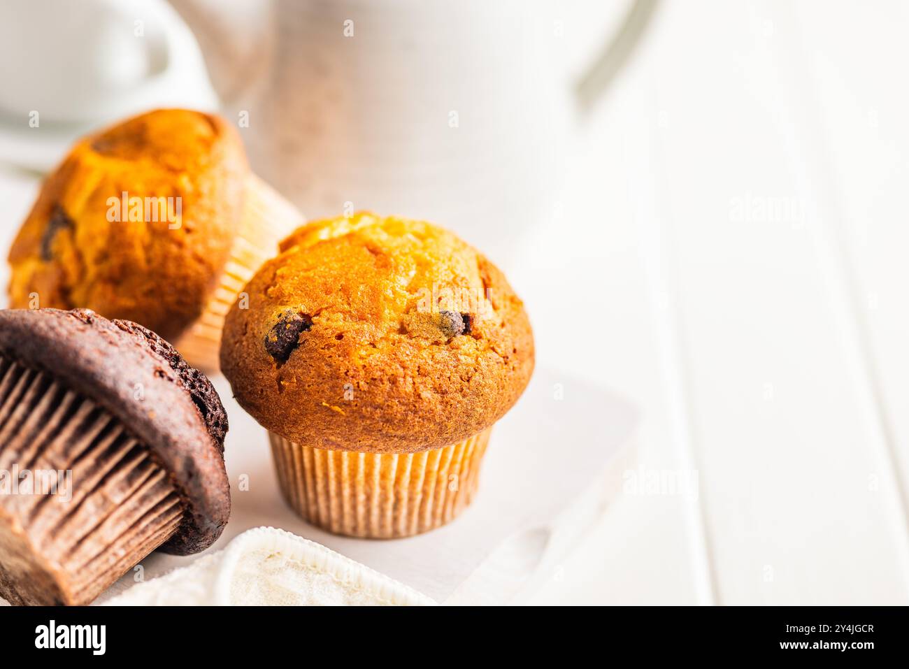 Sweet muffin cakes on a white table. Stock Photo