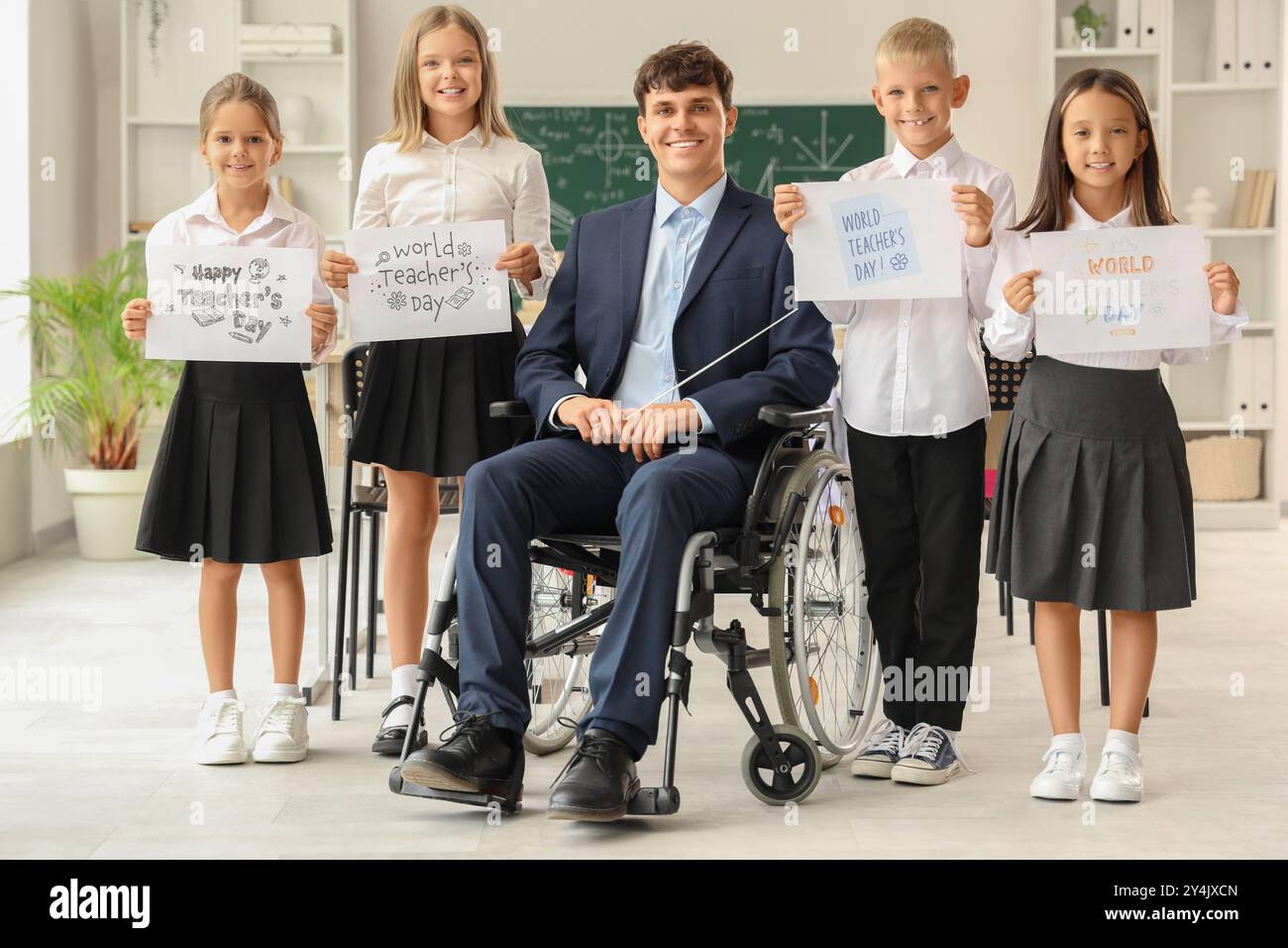 Male teacher in wheelchair and little pupils with greeting cards at ...