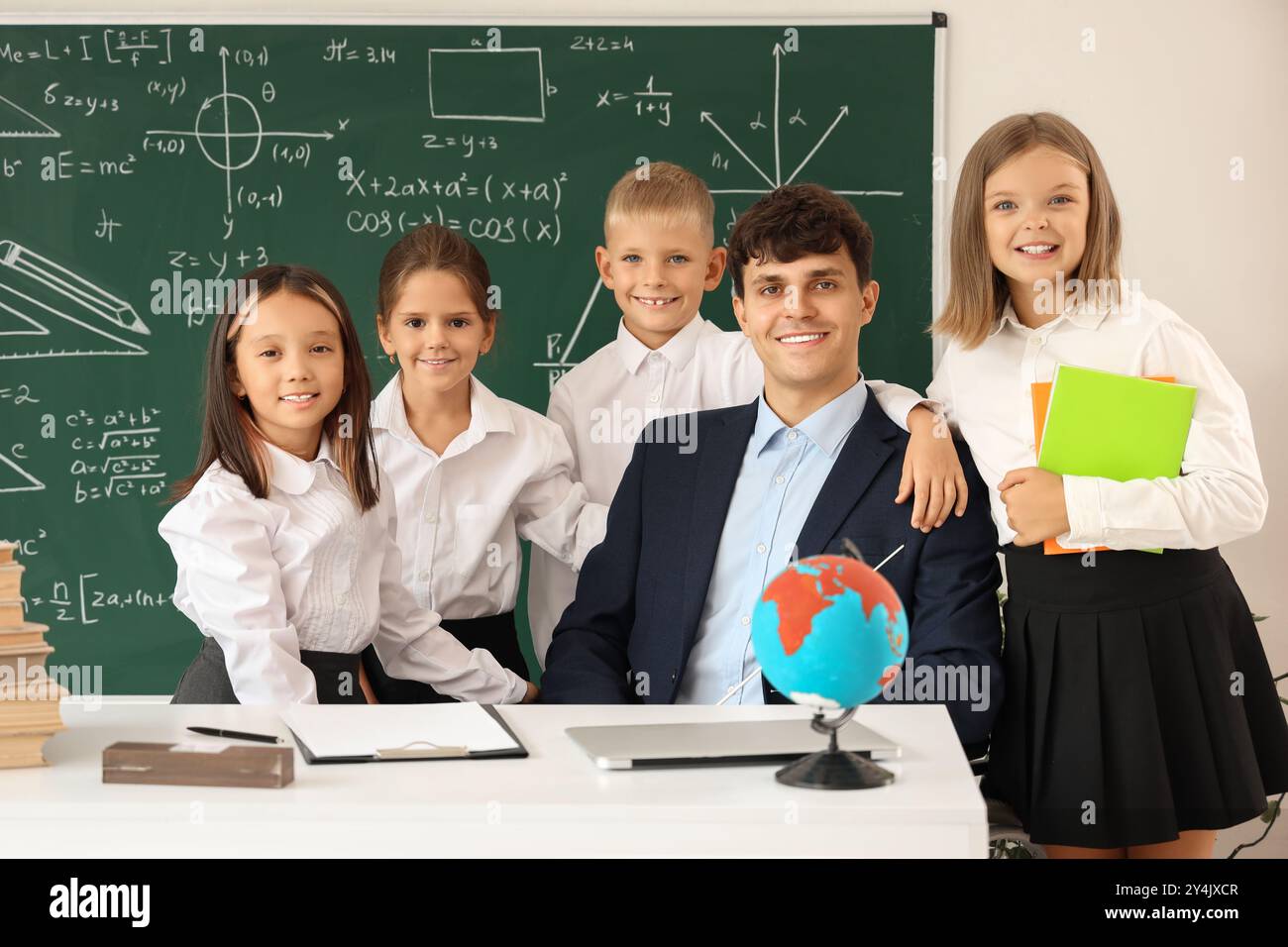 Male teacher in wheelchair with little pupils at school Stock Photo - Alamy