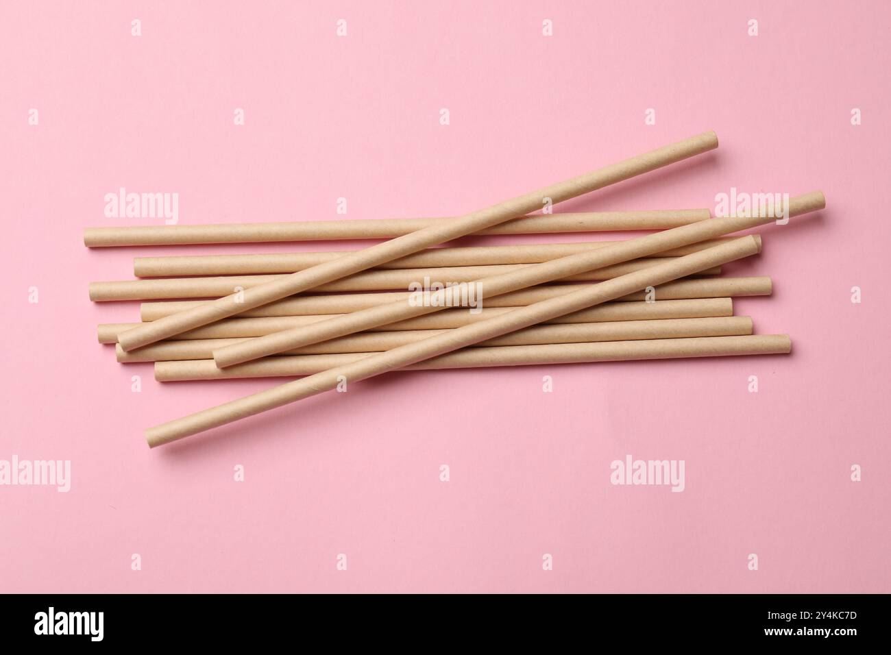 Bamboo drinking straws on pink background, top view Stock Photo