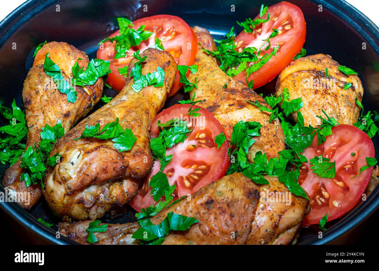 Baked chicken thighs with summer vegetables Stock Photo - Alamy