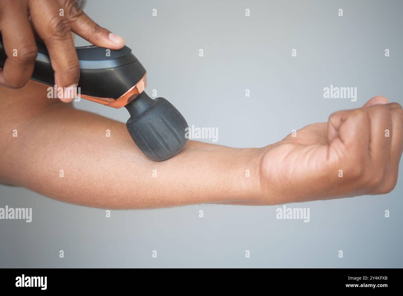 A Handheld Massage Device for ultimate relaxation and effective muscle recovery Stock Photo