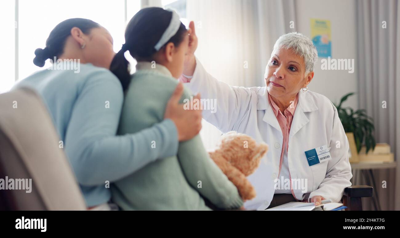 Doctor, child and check forehead at clinic, pediatrician and sick girl ...