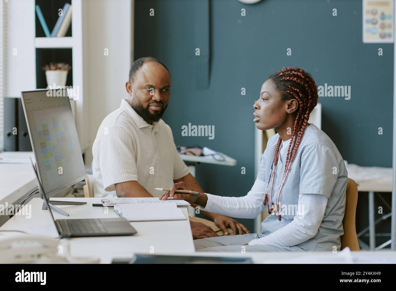 Discussing Project Goals in Modern Office Environment Stock Photo